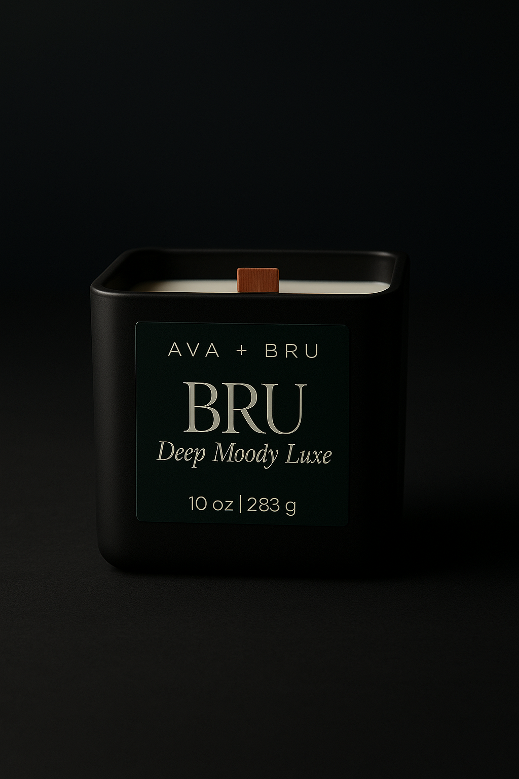 Black matte BRU candle with wood wick on a cinematic dark backdrop, labeled Deep Moody Luxe.