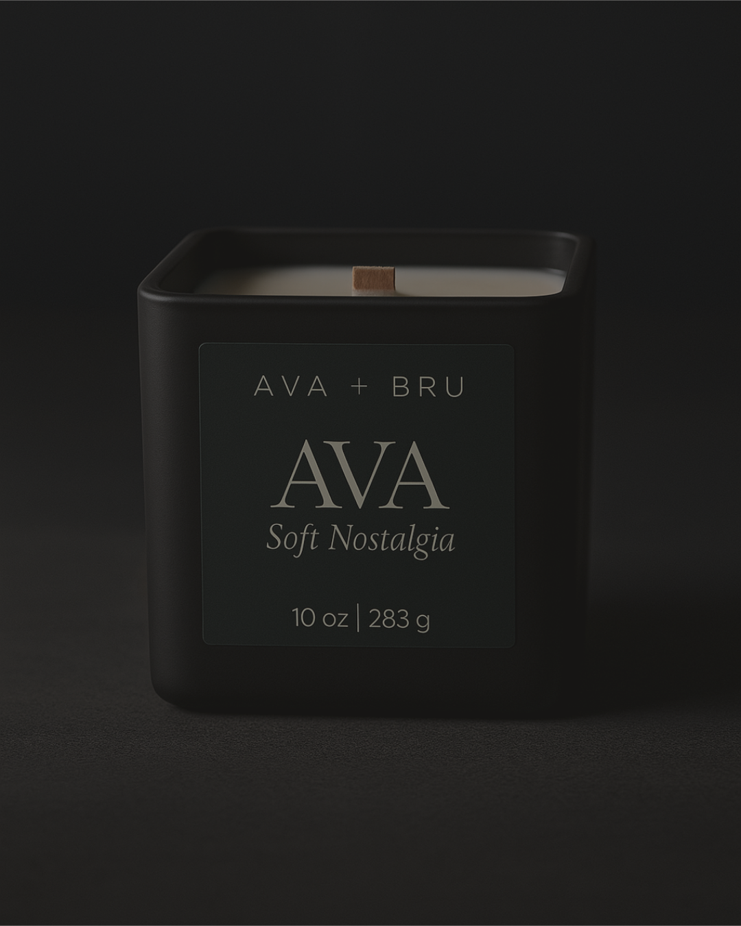 Black matte AVA candle with wood wick on a dark moody backdrop, labeled Soft Nostalgia.